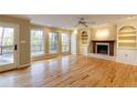 Spacious living room with fireplace, built-ins, hardwood floors, and access to the deck at 5385 Saffron Dr, Dunwoody, GA 30338