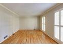 Bright living room featuring hardwood floors, crown molding and natural light at 5385 Saffron Dr, Dunwoody, GA 30338