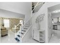 Elegant foyer featuring a staircase with decorative wrought iron railing at 6219 Wurtenburg Ct, Stone Mountain, GA 30087