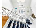 View of the foyer with chandelier, beautiful staircase and front door at 6219 Wurtenburg Ct, Stone Mountain, GA 30087