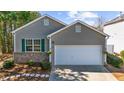Charming single-Gathering home with a well-maintained lawn and an attached two-car garage at 233 Hiawassee Dr, Woodstock, GA 30188