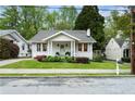 Inviting craftsman home boasts lush landscaping and a quaint front porch, adding curb appeal to the property at 6 Arc Ne Way, Atlanta, GA 30305