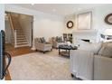 Bright living room features neutral decor, a fireplace with mantel, and hardwood floors with a soft rug at 6 Arc Ne Way, Atlanta, GA 30305