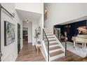 Inviting foyer featuring hardwood floors and a staircase with a modern railing at 7880 Brands Hatch Blvd, Cumming, GA 30040