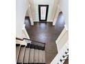 Elegant foyer with hardwood floors, decorative columns, and a beautiful front door with stained glass accents at 3988 Two Bridge Drive, Buford, GA 30519