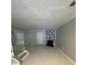 Bright living room features modern floors, statement fireplace, and wall to wall mirrors at 465 Prince Of Wales, Stone Mountain, GA 30083