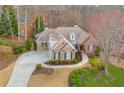Aerial view of a brick home with a circular driveway and well-maintained yard at 800 E Shore Dr, Canton, GA 30114