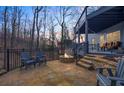 Outdoor stone patio with comfortable lounge chairs, a fire pit, and natural wooded views at 800 E Shore Dr, Canton, GA 30114