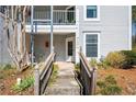 Close up exterior view of a doorway with access via steps and a walkway with views of garden landscape at 1321 Keys Lake Ne Dr, Brookhaven, GA 30319