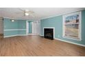 Bright living room featuring wood floors, fireplace, modern ceiling fan, and lovely contrasting trim at 1321 Keys Lake Ne Dr, Brookhaven, GA 30319