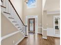 Bright foyer with hardwood floors, a decorative front door, and a staircase at 160 Antler Trl, Alpharetta, GA 30005