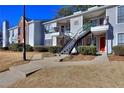 Attractive condo complex featuring neat landscaping, symmetrical stairs, and neutral paint at 586 Windchase Ln, Stone Mountain, GA 30083