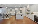 Bright kitchen features an island, stainless steel appliances, and beautiful hardwood floors at 3330 Camellia Ln, Suwanee, GA 30024