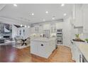Bright kitchen features an island, stainless steel appliances, and beautiful hardwood floors at 3330 Camellia Ln, Suwanee, GA 30024