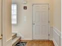 Entryway with a white six-panel door, hardwood floors, and neutral walls at 83 Brookway Trce, Norcross, GA 30071