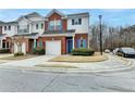 A brick townhome with white siding and blue shutters, situated on a cul-de-sac at 83 Brookway Trce, Norcross, GA 30071