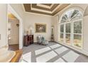 Bright sitting room with large arched window, coffered ceilings, and neutral color palette at 607 Delphinium Nw Blvd, Acworth, GA 30102