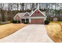 Attractive single-story home featuring stone accents, a long driveway, and a two-car garage at 28 Butler Park Ct, Dallas, GA 30157