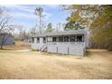 Charming single-story home with gray siding, black trim, and a welcoming front porch, perfect for relaxing outdoors at 2995 Clearwater Dr, Douglasville, GA 30135