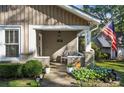 Inviting front porch with stone accents, a bench, and fresh landscaping at 1111 Seaboard Nw Ave, Atlanta, GA 30318