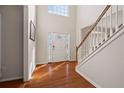 Bright foyer with hardwood floors, staircase, and decorated front door at 231 Beechwood Ln, Stone Mountain, GA 30087
