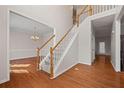 Bright foyer with hardwood floors, staircase, and view into the dining room at 231 Beechwood Ln, Stone Mountain, GA 30087