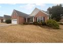 A well-maintained home exterior with a brick facade and dark shutters, offering a classic look and landscaped yard at 1446 Dunton Green Way, Lawrenceville, GA 30043