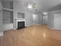 Spacious living room with hardwood floors, a fireplace, and ample natural light at 1446 Dunton Green Way, Lawrenceville, GA 30043