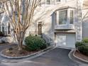 Close up on charming townhome featuring an attached garage, front yard landscaping, and neutral paint scheme at 1532 Oak Grove Rd, Decatur, GA 30033