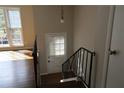 Entryway with hardwood flooring and railing, featuring a large window for natural light at 2491 Hatfield Cir, Atlanta, GA 30316