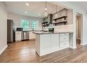 Well-lit kitchen with stainless steel appliances, a kitchen island, and hardwood flooring at 2797 Gresham Se Rd, Atlanta, GA 30316