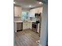 Modern kitchen featuring stainless steel appliances, white cabinetry, and stylish countertops at 316 Henry Aaron Ave, Atlanta, GA 30310