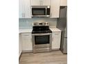 Well equipped kitchen with stainless steel oven, microwave and sleek countertops at 316 Henry Aaron Ave, Atlanta, GA 30310