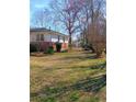 Lush backyard with mature trees and partial fence, providing a private and peaceful setting at 3800 Whitaker Ln, Lithia Springs, GA 30122
