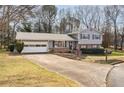 Charming two-story home featuring a well-maintained front yard with established landscaping at 2690 Manassas Pl, Snellville, GA 30039