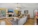 Cozy living room with fireplace, bamboo flooring, and vaulted ceiling at 3231 Boulder Brook Dr, Lithonia, GA 30038