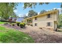 Well-maintained home with landscaped yard featuring mature plantings at 3231 Boulder Brook Dr, Lithonia, GA 30038