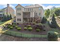 Spacious backyard with lush landscaping, fence, multilevel deck, and patio perfect for outdoor living at 4070 Preserve Crossing Ln, Cumming, GA 30040
