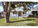 Exterior showcasing a cozy gray bungalow with a charming front porch and a fenced yard at 1084 Kirkwood Se Ave, Atlanta, GA 30316