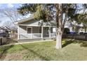 Cozy home featuring a classic porch with white railings and a charming fenced yard on a sunny day at 1084 Kirkwood Se Ave, Atlanta, GA 30316