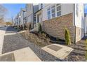 Street view showing the modern townhome architecture with stone accents and professionally landscaped front yard at 481 Hammons Way, Atlanta, GA 30315