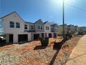 Row of new construction townhomes featuring covered garages, light-colored exteriors, and contemporary design at 11612 E Lovejoy Rd, Hampton, GA 30228