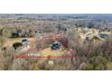 Expansive aerial view showcasing the 2.98-acre lot, mature trees, providing privacy and seclusion, and the layout of the house at 351 Allendale Dr, Canton, GA 30115