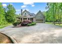 Inviting home exterior boasts manicured landscaping, a spacious driveway, and a charming covered porch at 351 Allendale Dr, Canton, GA 30115