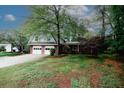 Charming two-story home features a brick facade, attached two-car garage and a well-manicured front lawn with mature trees at 4144 Hideaway Dr, Tucker, GA 30084