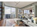 Bright, open living room with floor-to-ceiling windows, hardwood floors, and modern furnishings at 855 Peachtree Ne St # 2801, Atlanta, GA 30308