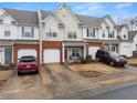 Charming townhome with a brick facade and attached garage, showcasing inviting curb appeal in a residential setting at 2427 Millbank Ct, Lawrenceville, GA 30043