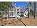 Lovely two-story home with a well-manicured lawn and lush trees at 1303 Angel Falls Sw Ln, Atlanta, GA 30311