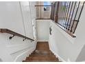 Staircase featuring hardwood steps and modern railings, leading to the lower level of the home at 375 Banbury Xing, Alpharetta, GA 30009