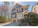 Charming exterior of a brown two-story home with a two-car garage and landscaped front yard at 2647 Brickell Sq, Atlanta, GA 30341